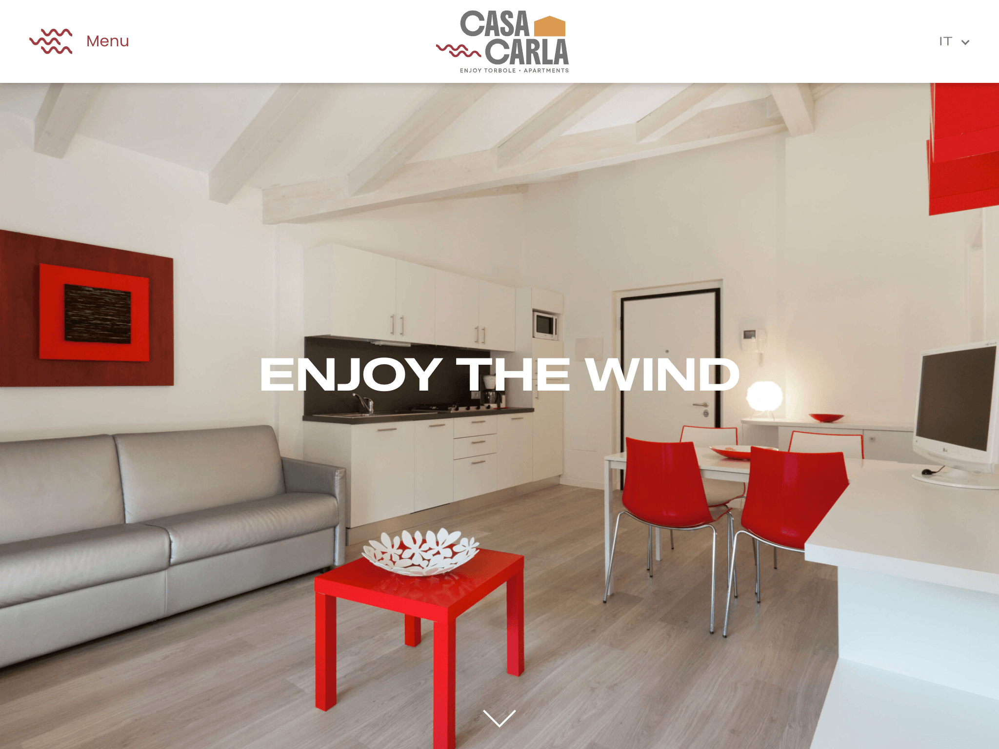 Casa Carla apartment interior with open-plan living area and Enjoy the Wind headline